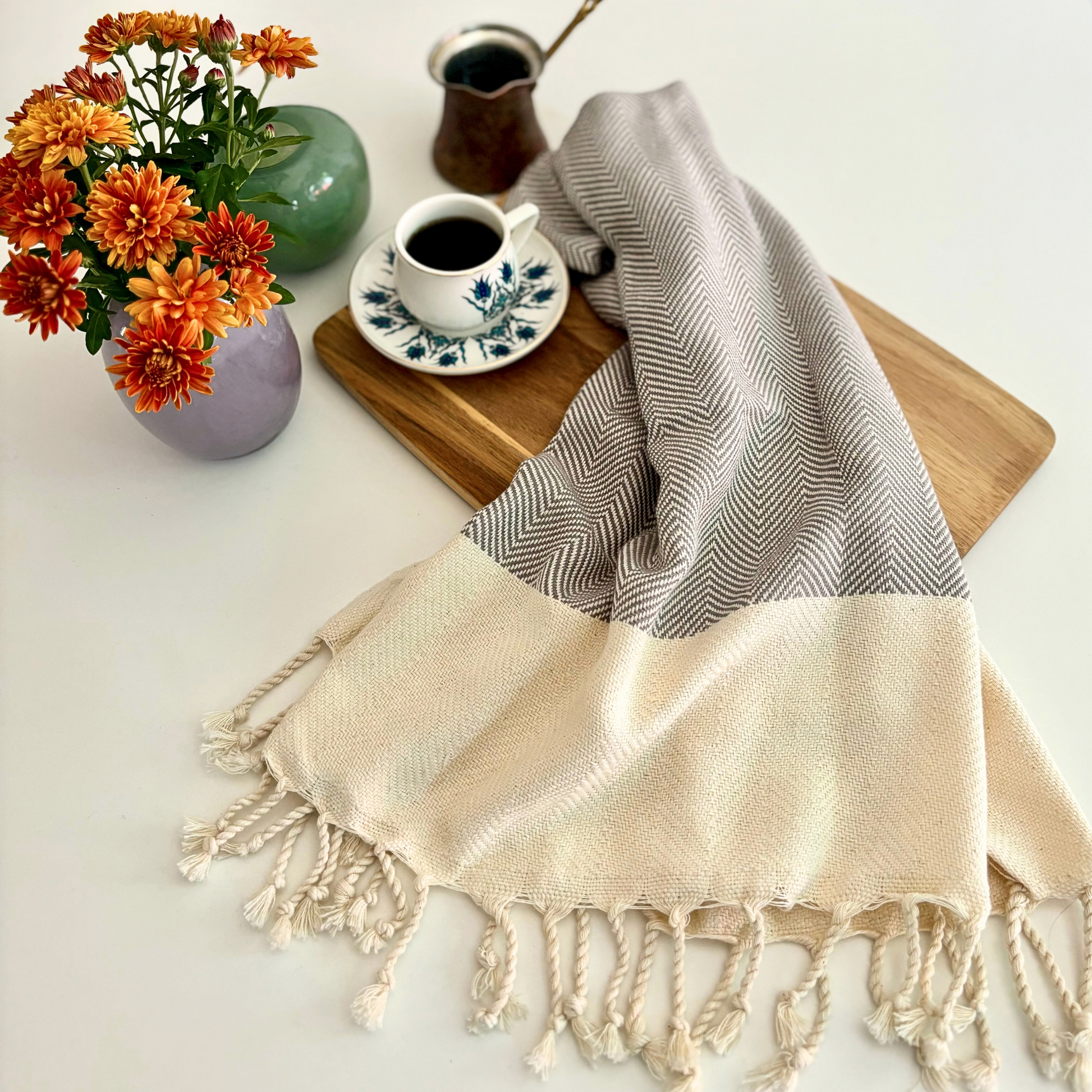 DOVE Turkish Hand Towel with a soft grey herringbone pattern, displayed with flowers and coffee for a cozy home setting.