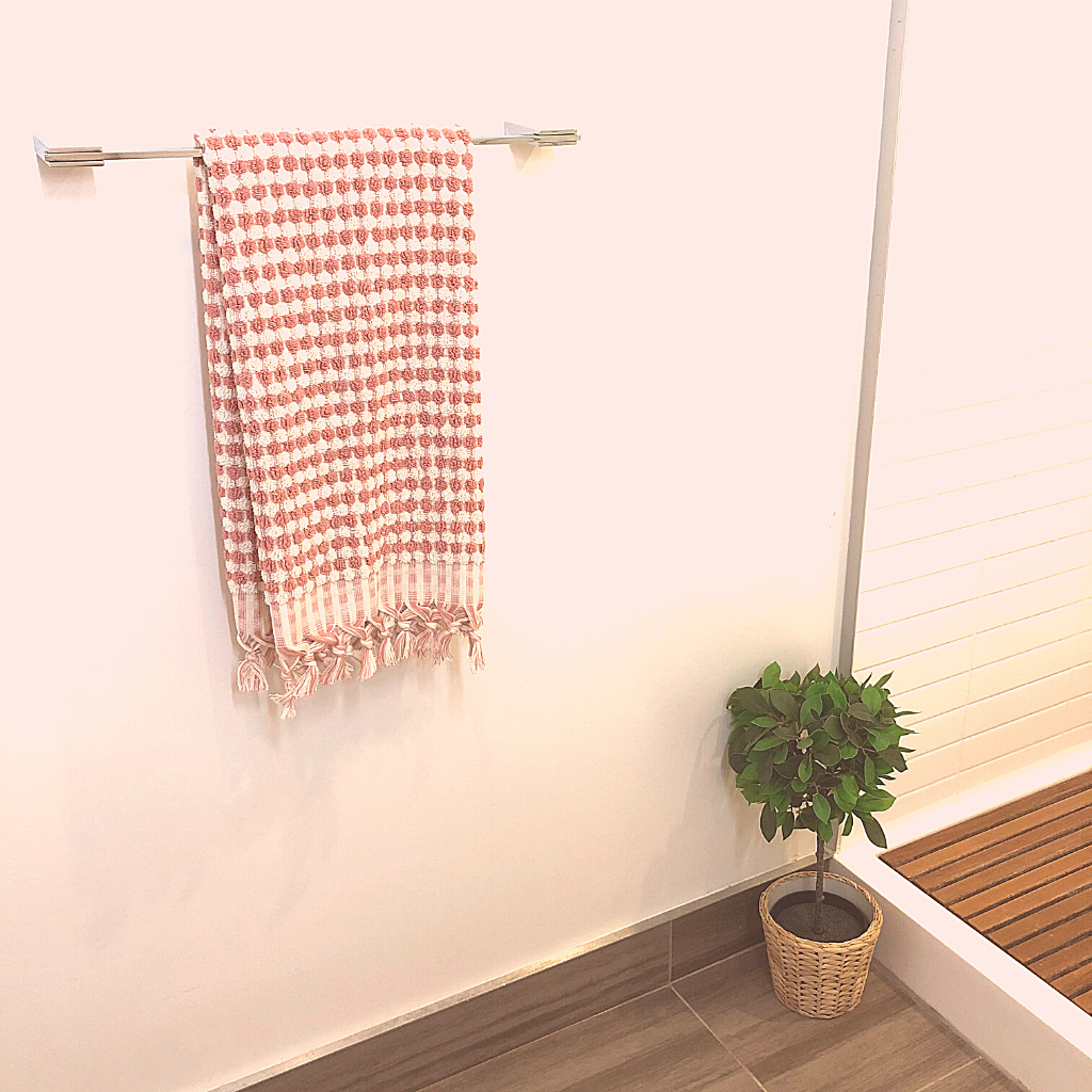 Coral pink DOTS Terry Hand Towel hanging in bathroom